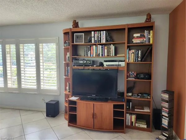 a room with furniture a window and a bed