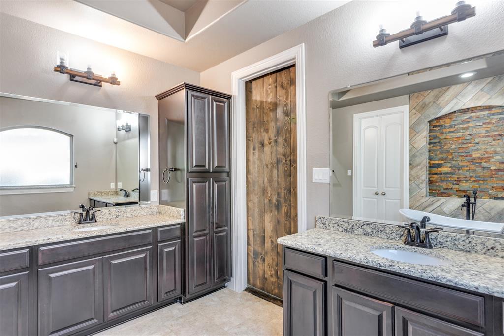 1505 5th Street Argyle, TX 76226 - Photo 17 of 25 a bathroom with a granite countertop sink double vanity and a mirror