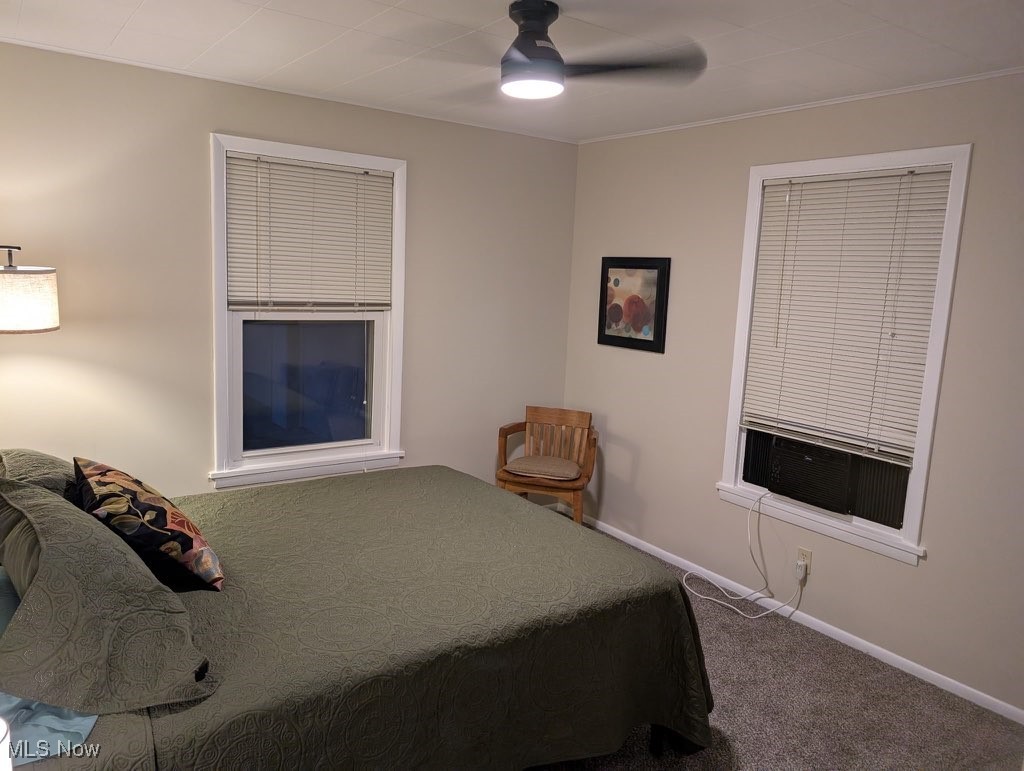 5860 Haber Road Vermilion, OH 44089 - Photo 18 of 31 Bedroom featuring carpet flooring, cooling unit, ceiling fan, and ornamental molding