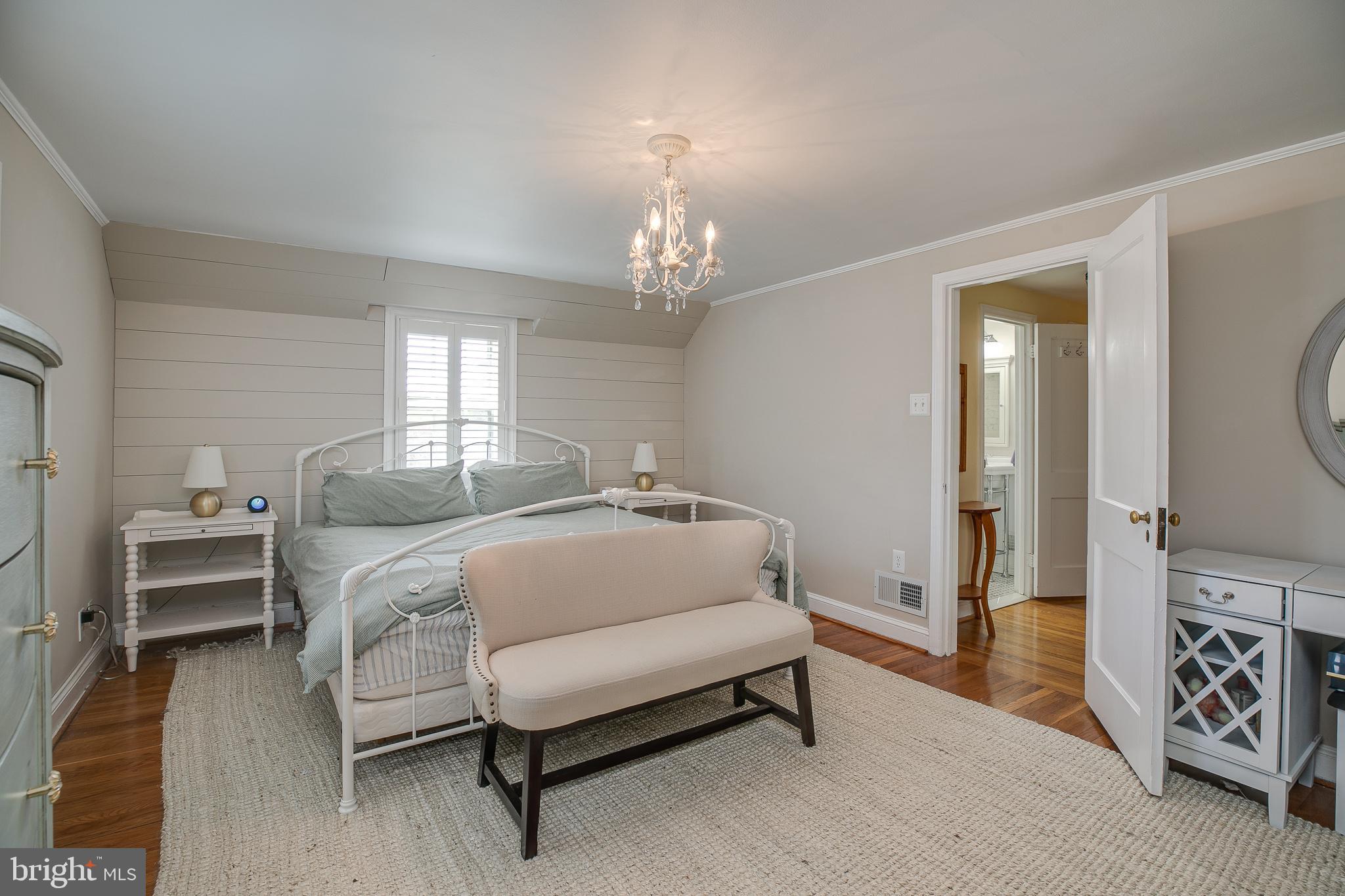 330 Old Lancaster Road Devon, PA 19333 - Photo 20 of 31 a spacious bedroom with a bed and a chandelier