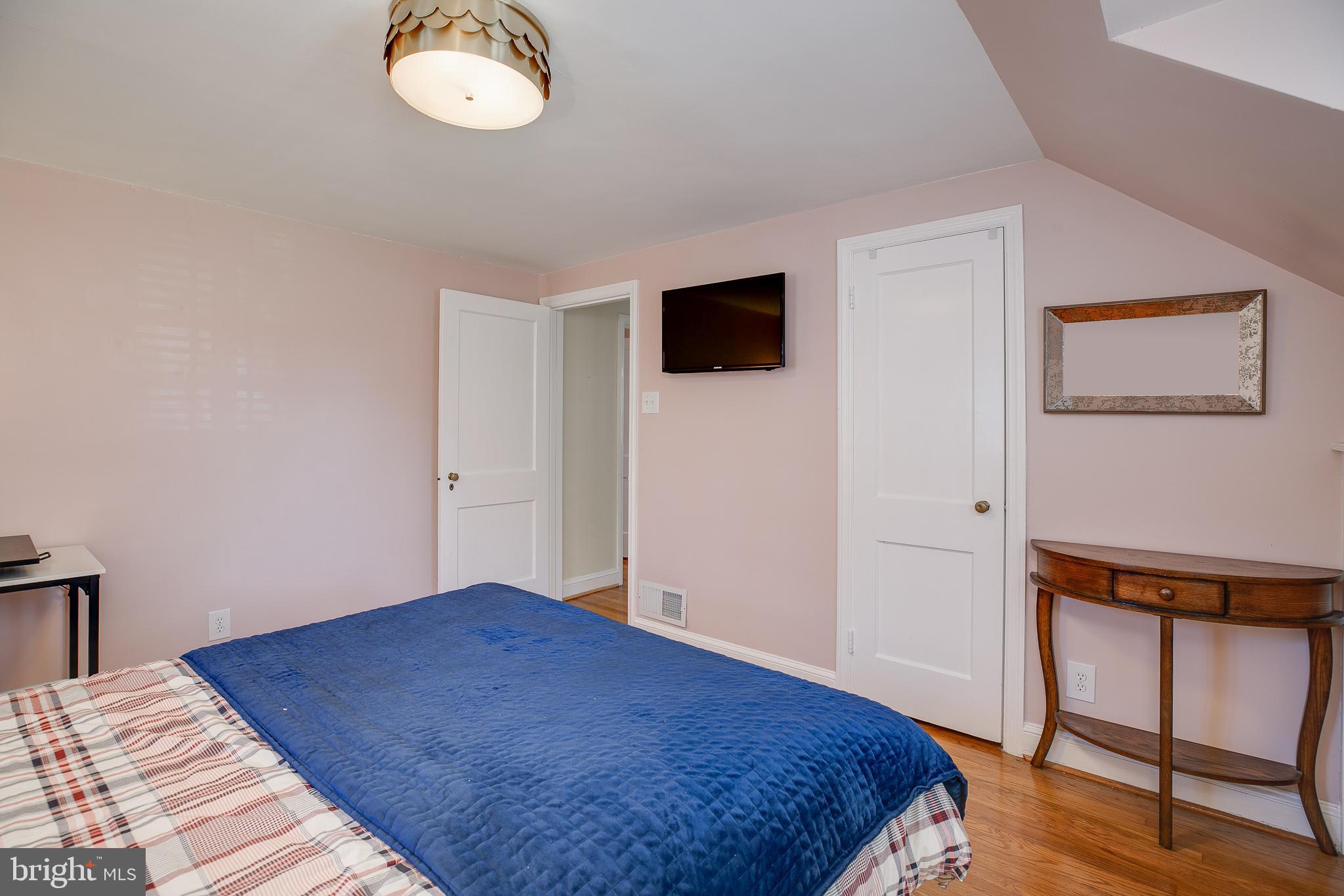 330 Old Lancaster Road Devon, PA 19333 - Photo 24 of 31 a bedroom with a bed and a lamp on dresser