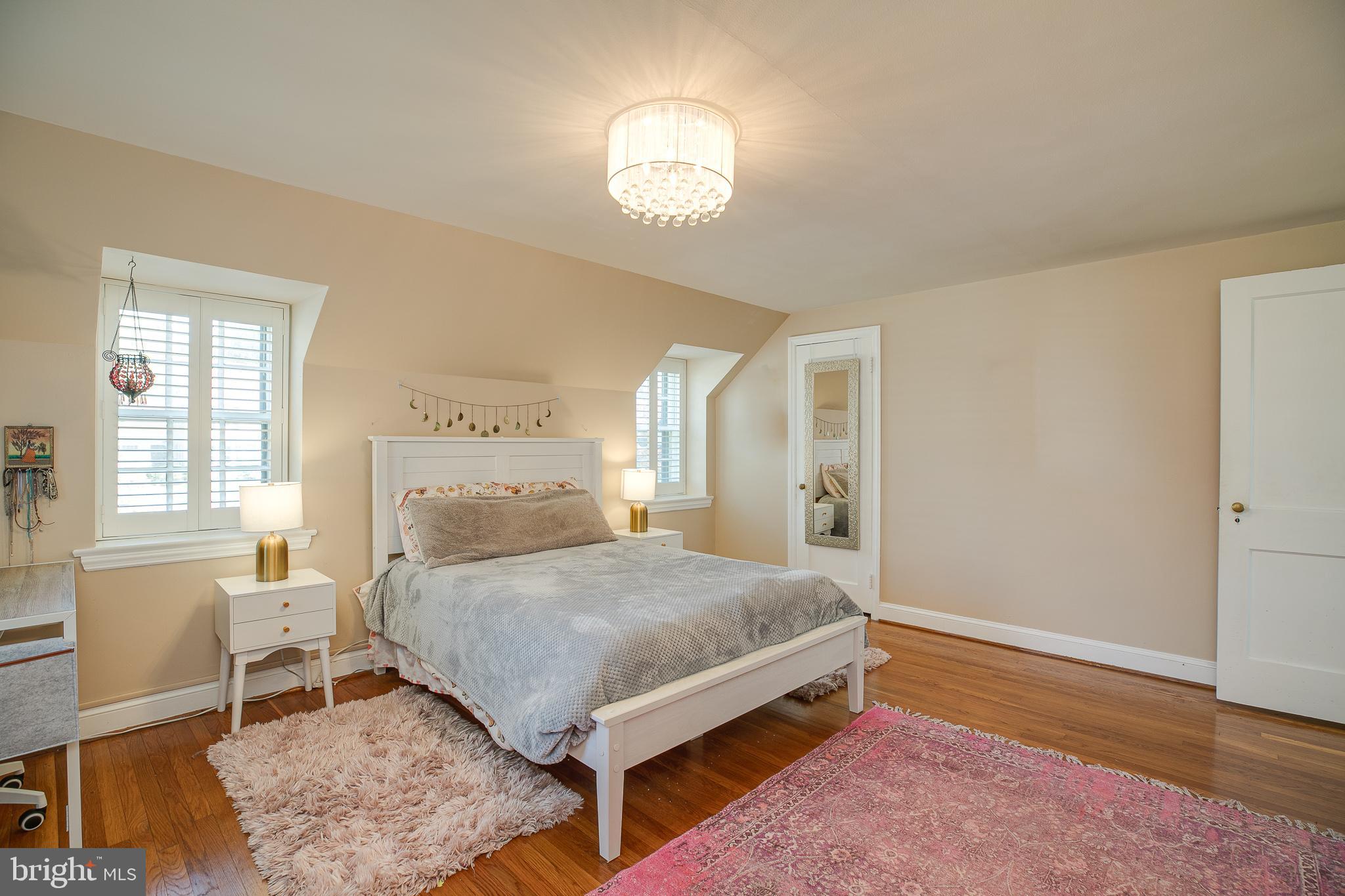 330 Old Lancaster Road Devon, PA 19333 - Photo 27 of 31 a spacious bedroom with a bed and a table in it