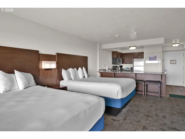 a large bedroom with a bed and window