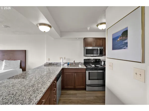 a kitchen with stainless steel appliances granite countertop a stove and a refrigerator