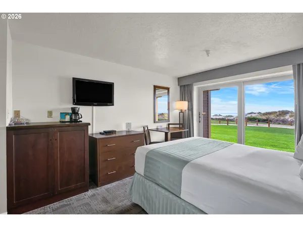a bedroom with a bed and a television