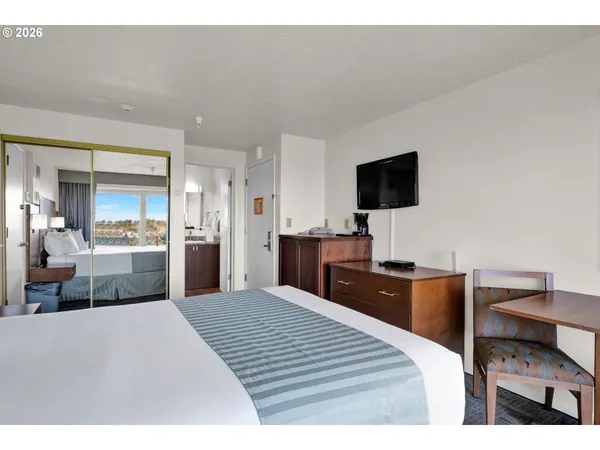 a bedroom with a bed and a flat screen tv