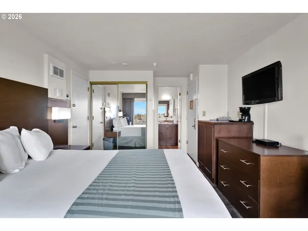 a bedroom with a bed and a flat screen tv