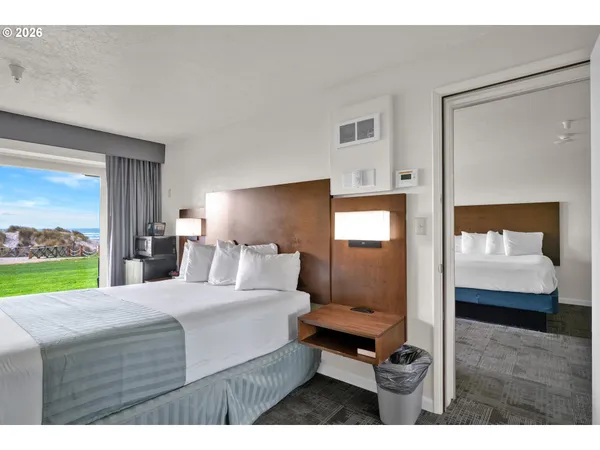 a bedroom with a bed and a mirror