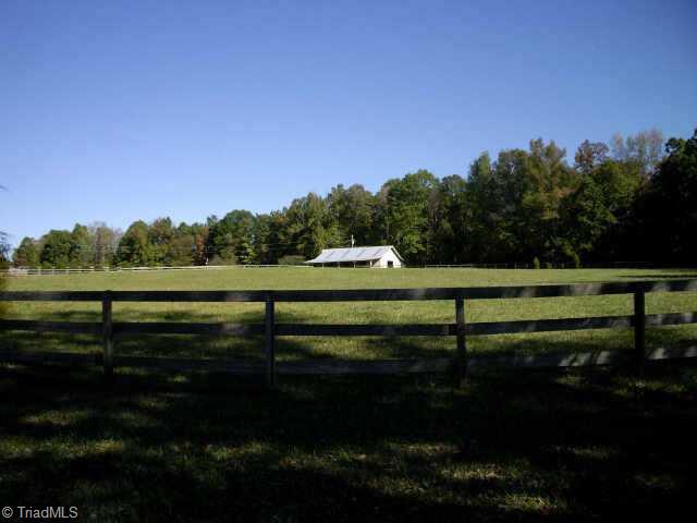 4811 New Sharon Church Road Hillsborough, NC 27278 - Photo 2 of 9 Other. One view of the 4-5 acre fenced pasture with the 5-stall barn in the backgound.