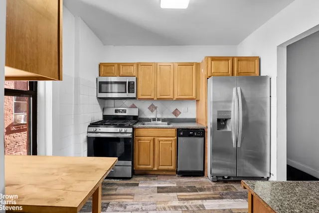 a view of livingroom with kitchen view and wooden floor