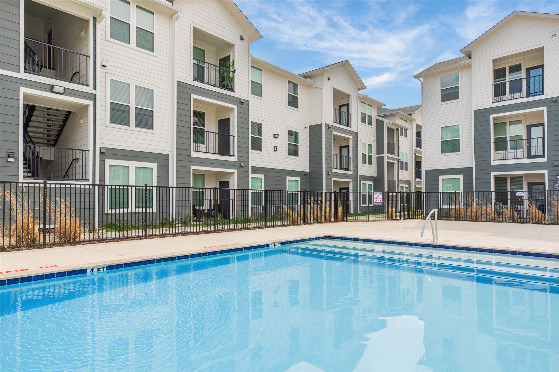 14809 Ralston Road, Unit A18302 Humble, TX 77396 - Photo 15 of 16 a view of an apartment building with a swimming pool