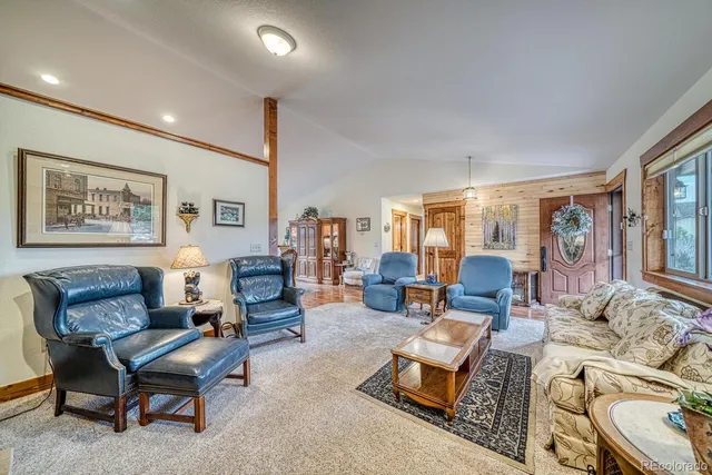 a living room with furniture gym equipment and large window