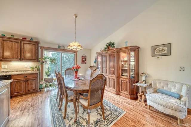 a dining room with furniture a chandelier and wooden floor