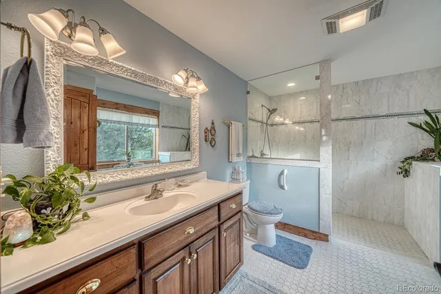 a bathroom with a sink toilet and shower