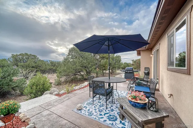 a patio with a patio table and chairs