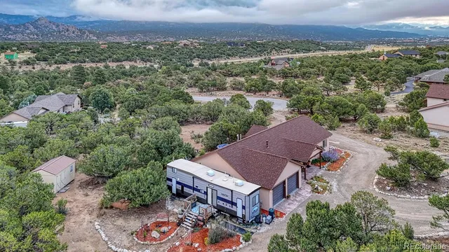 an aerial view of a house with a yard