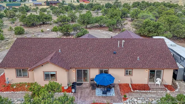a aerial view of a house with table and chairs and a fire pit