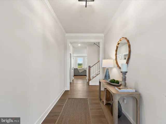 a kitchen with stainless steel appliances granite countertop a stove top oven a sink dishwasher a dining table and chairs with wooden floor