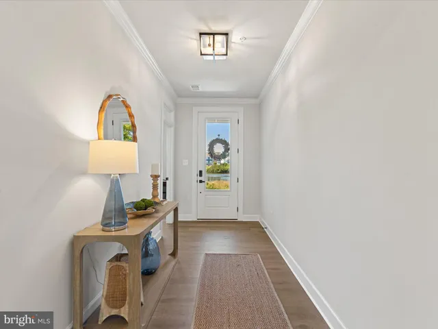 a hallway with painting on the wall and a window