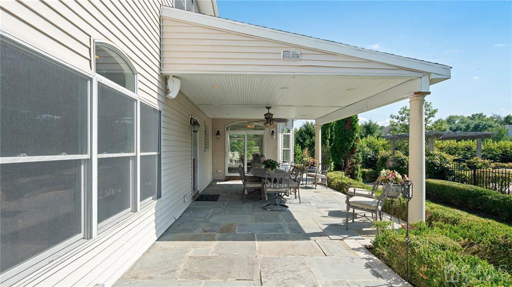 5 Daisy Court Skillman, NJ 08558 - Photo 11 of 50 a view of a patio with table and chairs potted plants with floor to ceiling window