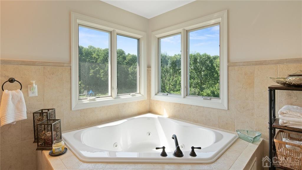 5 Daisy Court Skillman, NJ 08558 - Photo 40 of 50 a white bath tub sitting in a bathroom next to a window