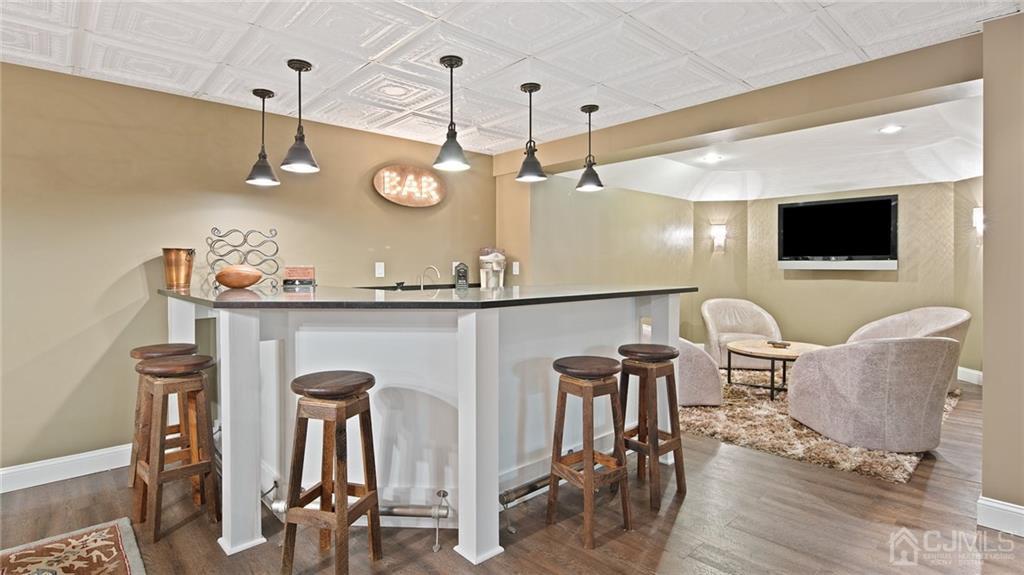 5 Daisy Court Skillman, NJ 08558 - Photo 43 of 50 a living room with furniture a flat screen tv and kitchen view