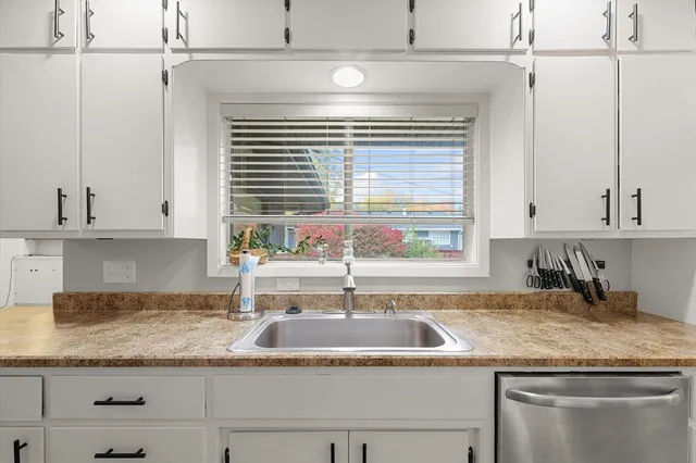a view of a dining room with furniture a chandelier and wooden floor