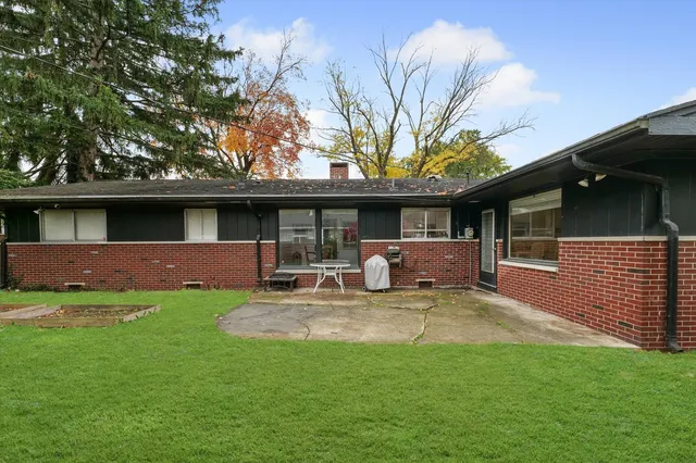 a front view of a house with a yard table and chairs