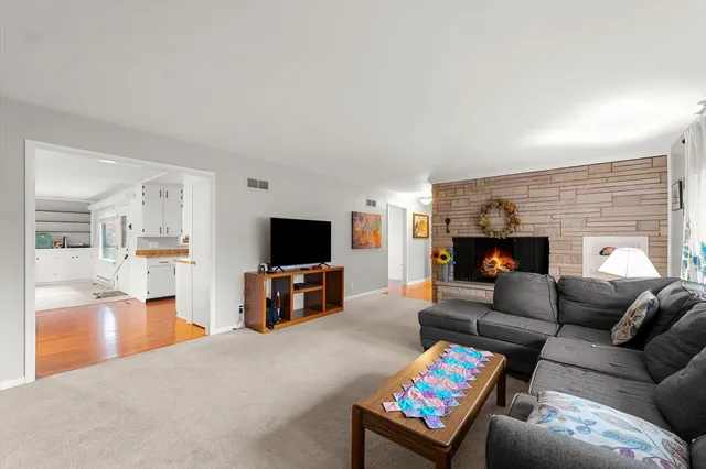 a living room with furniture and a fireplace