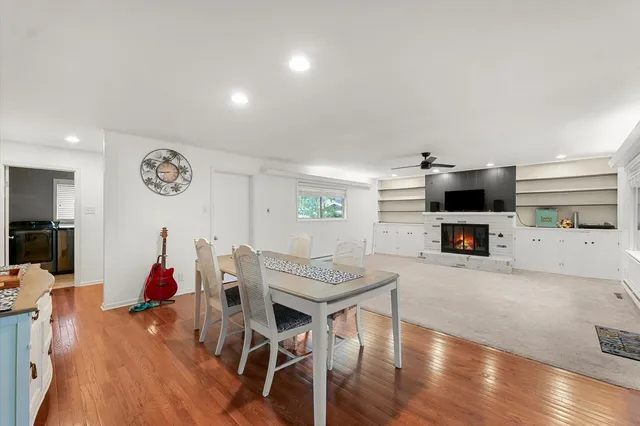 a view of a livingroom with an empty space and a kitchen