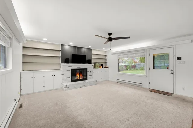 a view of a livingroom with furniture and a ceiling fan