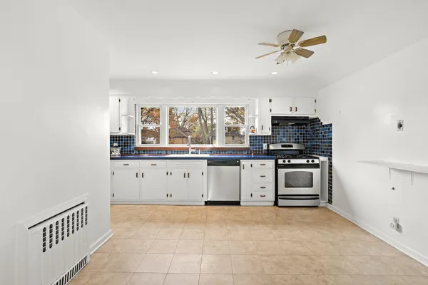 a kitchen with stainless steel appliances a stove and a refrigerator