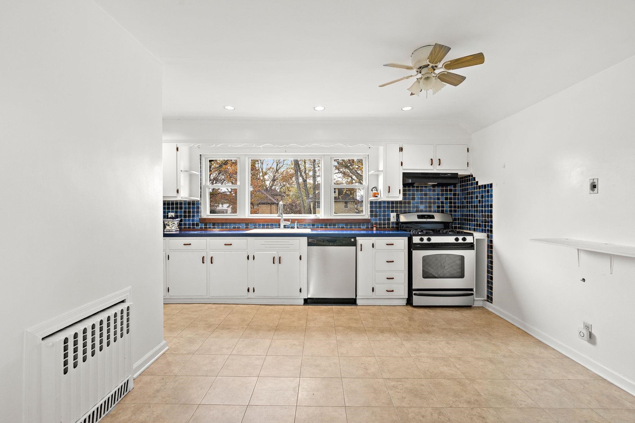 97 Riverview Avenue Cliffside Park, NJ 07010 - Photo 11 of 26 a kitchen with stainless steel appliances a stove and a refrigerator