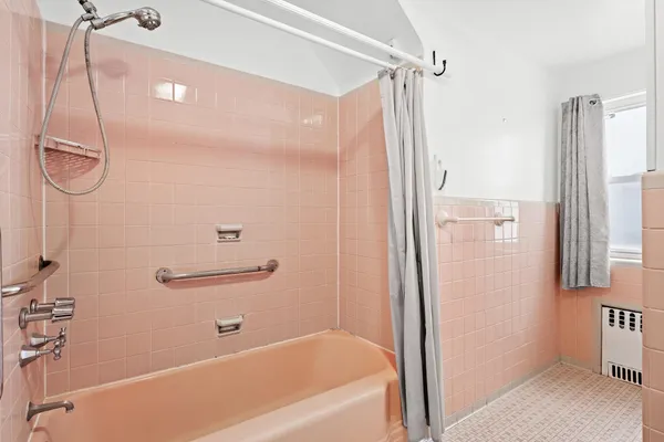 a bathroom with a bathtub and a shower