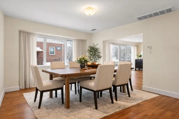 a view of a dining room with furniture window and wooden floor