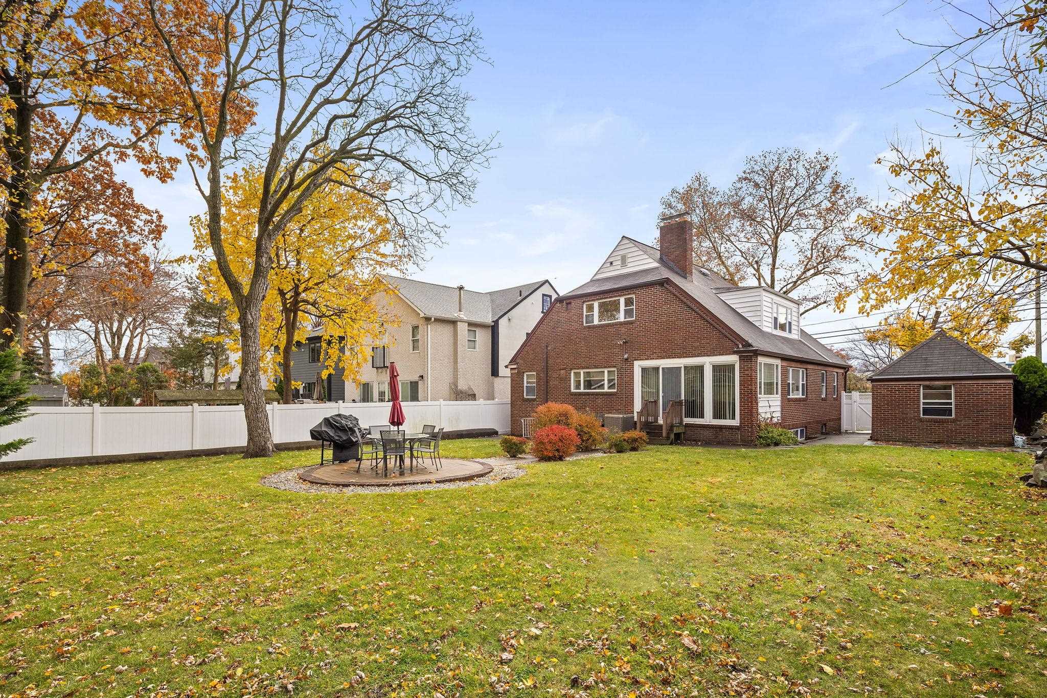 97 Riverview Avenue Cliffside Park, NJ 07010 - Photo 21 of 26 a view of a house with a big yard and large trees