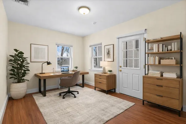 a view of a workspace with furniture and window