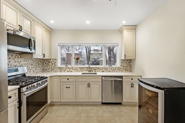 a kitchen with stainless steel appliances granite countertop a stove and a sink