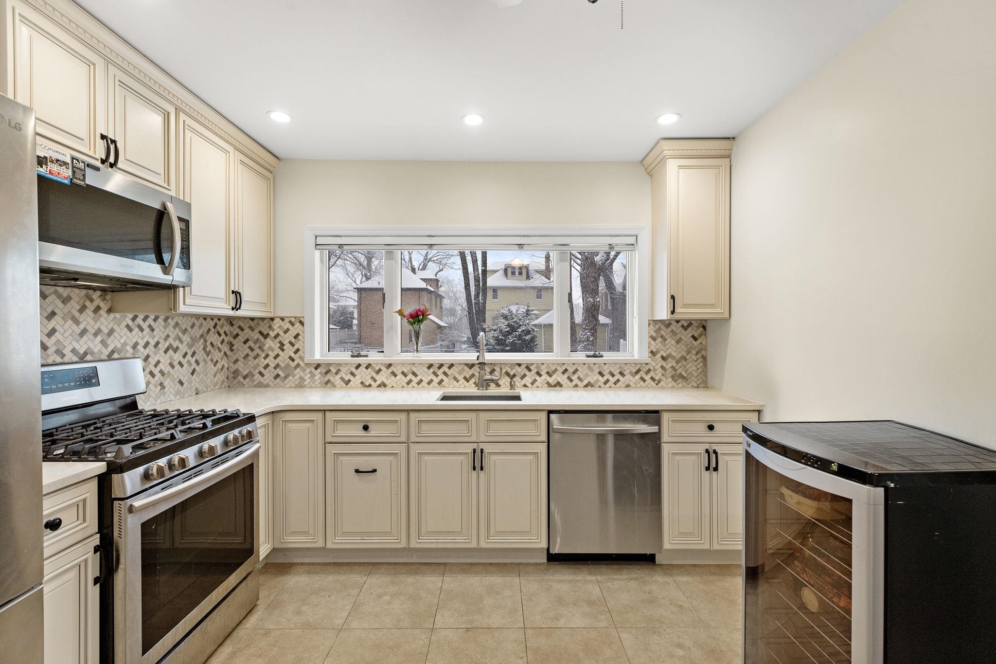 97 Riverview Avenue Cliffside Park, NJ 07010 - Photo 6 of 26 a kitchen with stainless steel appliances granite countertop a stove and a sink