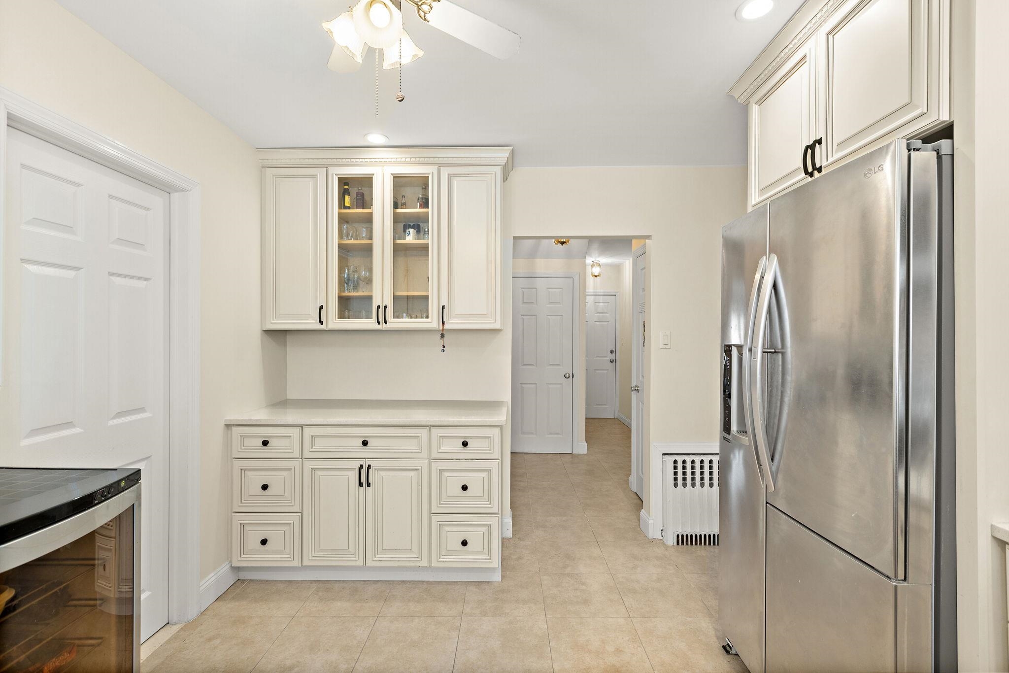 97 Riverview Avenue Cliffside Park, NJ 07010 - Photo 7 of 26 a kitchen with white cabinets and refrigerator