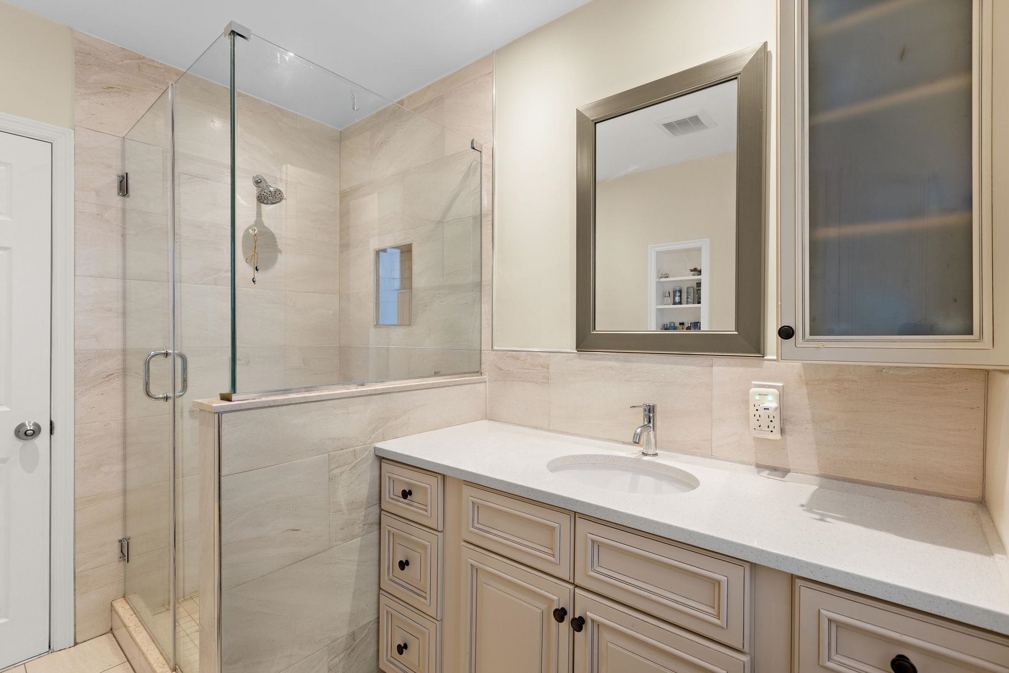 97 Riverview Avenue Cliffside Park, NJ 07010 - Photo 9 of 26 a bathroom with a shower sink and mirror