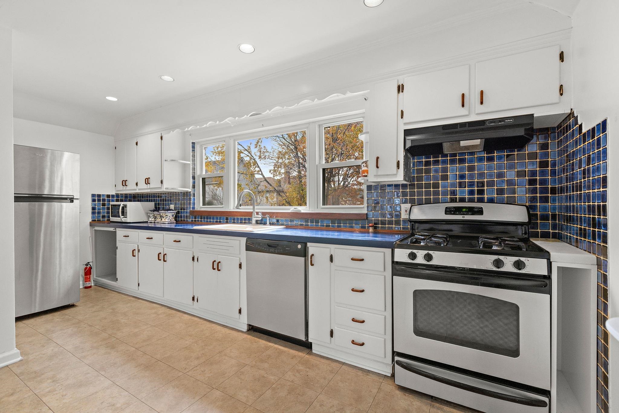 97 Riverview Avenue Cliffside Park, NJ 07010 - Photo 10 of 26 a kitchen with granite countertop cabinets stainless steel appliances and a window