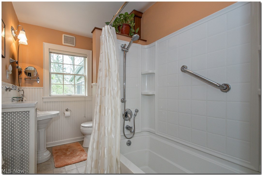 3034 East Overlook Road Cleveland, OH 44118 - Photo 27 of 35 The full bath on the second floor has a tub/shower combination, bead board wainscoting, extra cabinetry for storage.