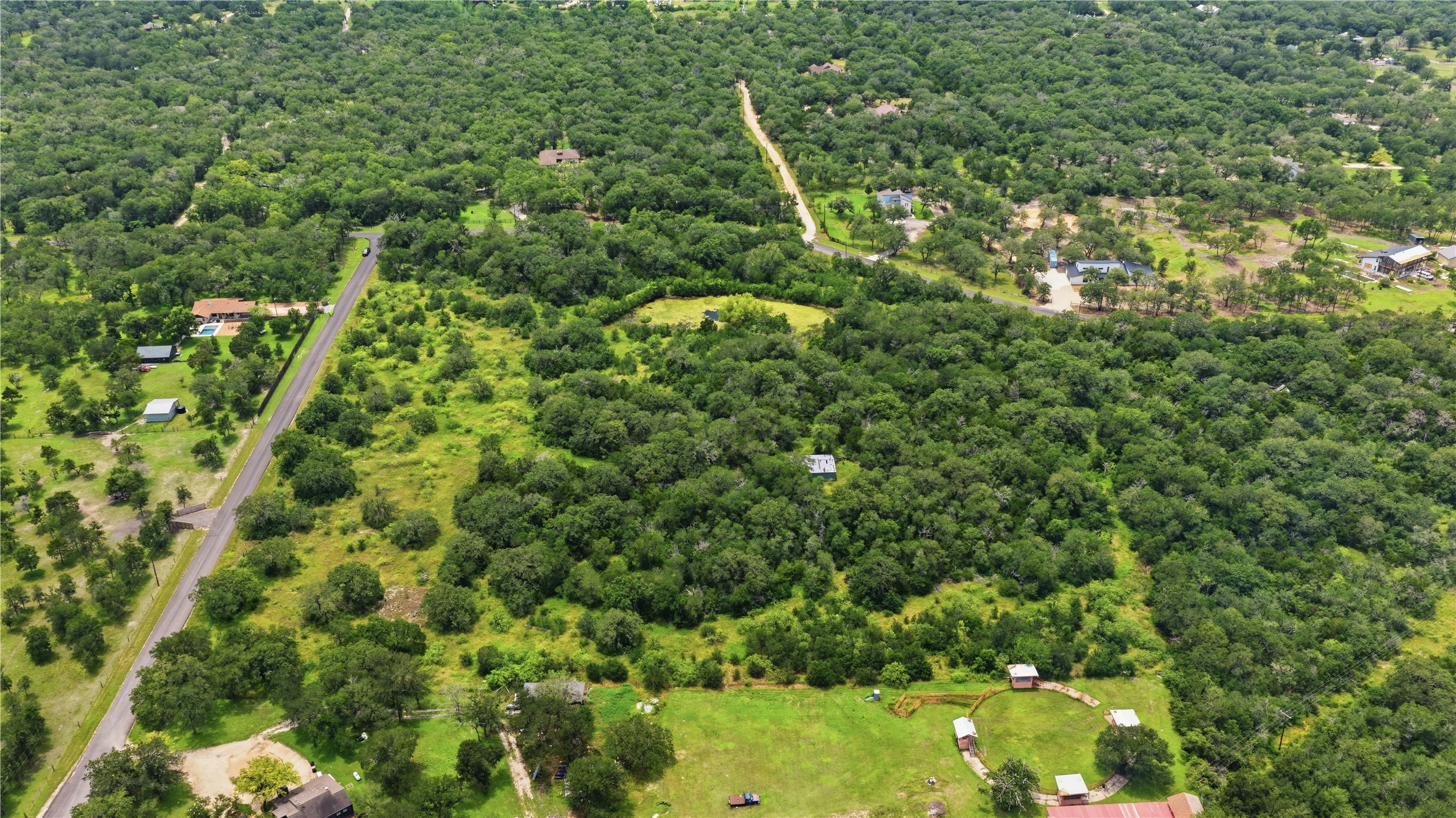 10312 Parsons Road Manor, TX 78653 - Photo 9 of 26 An aerial perspective reveals a sprawling, verdant landscape with abundant trees and open land.