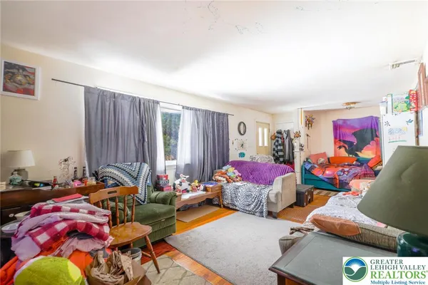 a living room with furniture a rug and a window