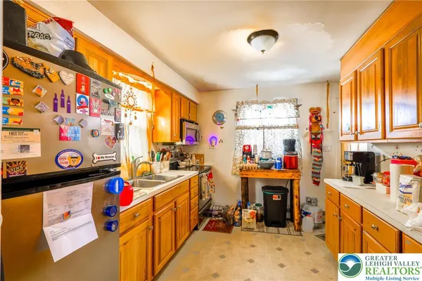 a view of a kitchen with fridge and window