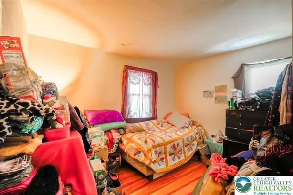 a bedroom with a bed and a potted plant