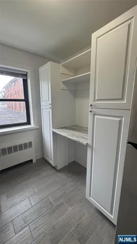 a view of room with window and cabinet