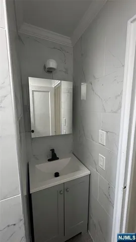 a bathroom with a sink vanity and mirror