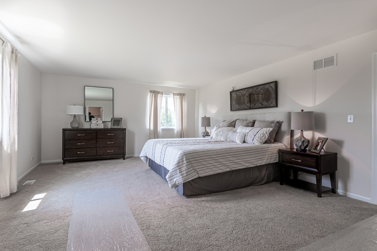 901 Willow Road Manteno, IL 60950 - Photo 14 of 17 a spacious bedroom with a bed and a window